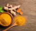 flat-lay-top-view-turmeric-curcumin-powder-wooden-bowl-spoon-with-fresh-rhizome-wood-background_252965-741